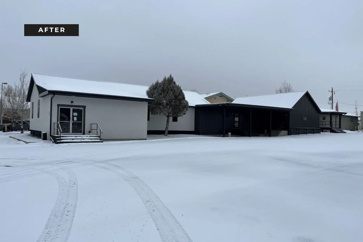 Completed exterior commercial construction of Big Horn Pediatrics medical clinic under snow by Buffalo Built LLC.
