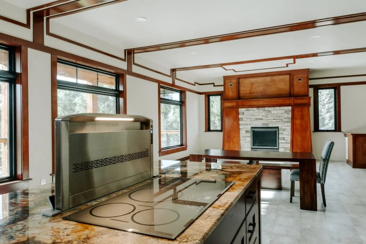 Luxury open concept kitchen and living area featuring custom craftsman trim work by Buffalo Built LLC in Buffalo, WY.