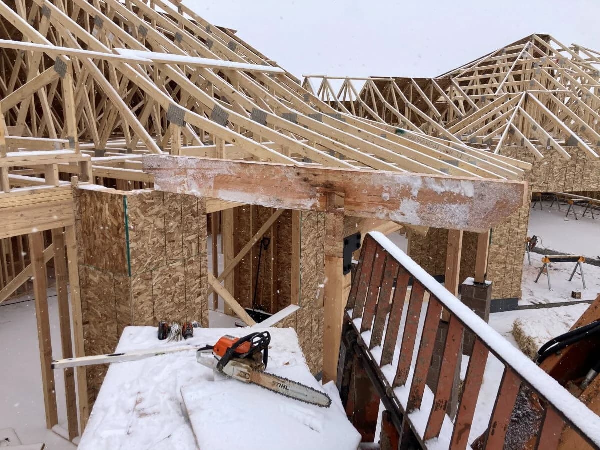 Complex engineered roof truss framing during the construction of a custom residential home by Buffalo Built LLC in Laramie, WY.