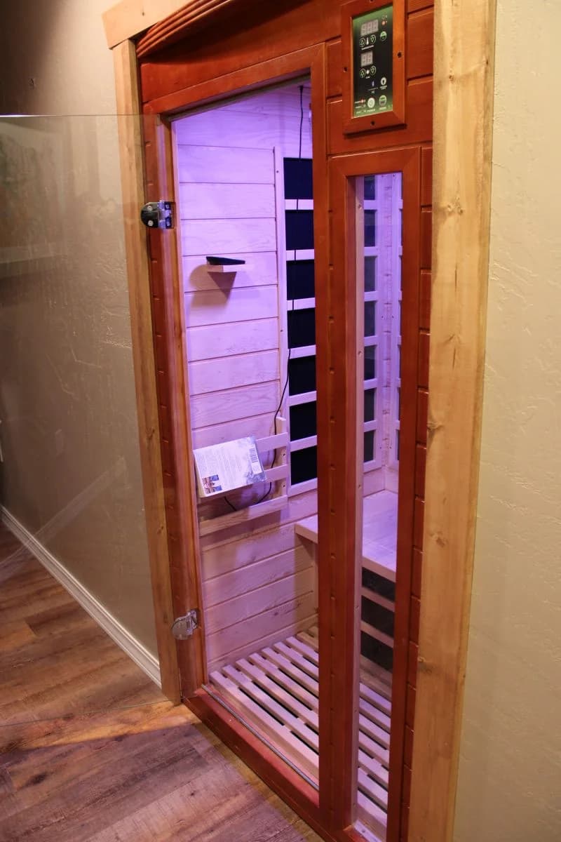 Built-in indoor home sauna addition with custom wood trim framing and a glass door installed by Buffalo Built LLC in Sheridan Wyoming.