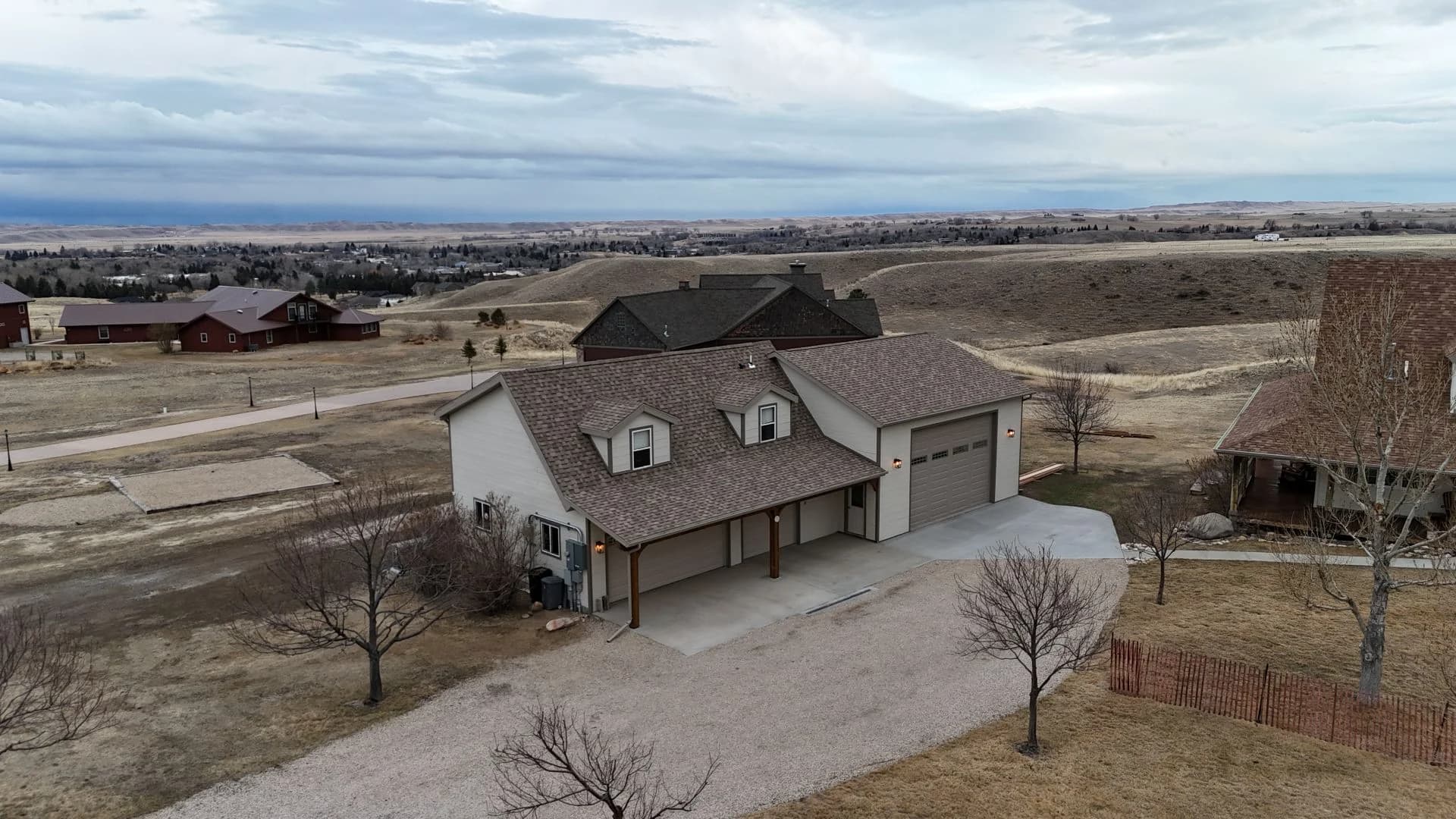 Premium residential home addition featuring a detached two-story multi-car garage with roof dormers completed by Buffalo Built LLC.