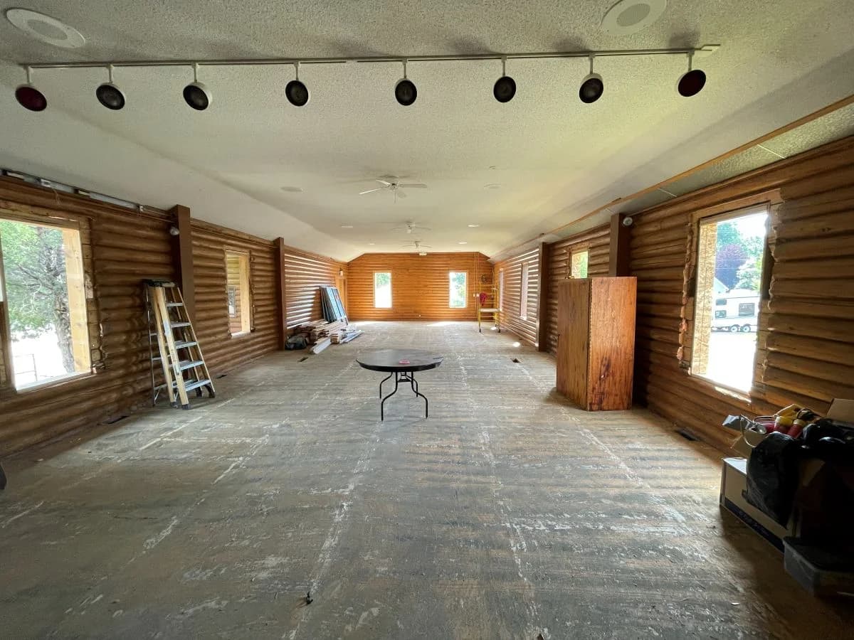 Active interior rough-in framing phase inside a large commercial log facility project by Buffalo Built LLC.