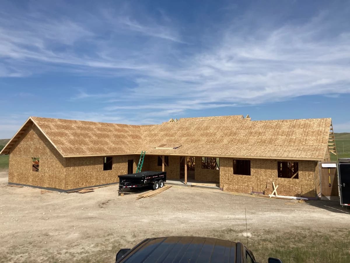 Custom home rough-in phase showcasing completed OSB wall and roof sheathing by Buffalo Built LLC.