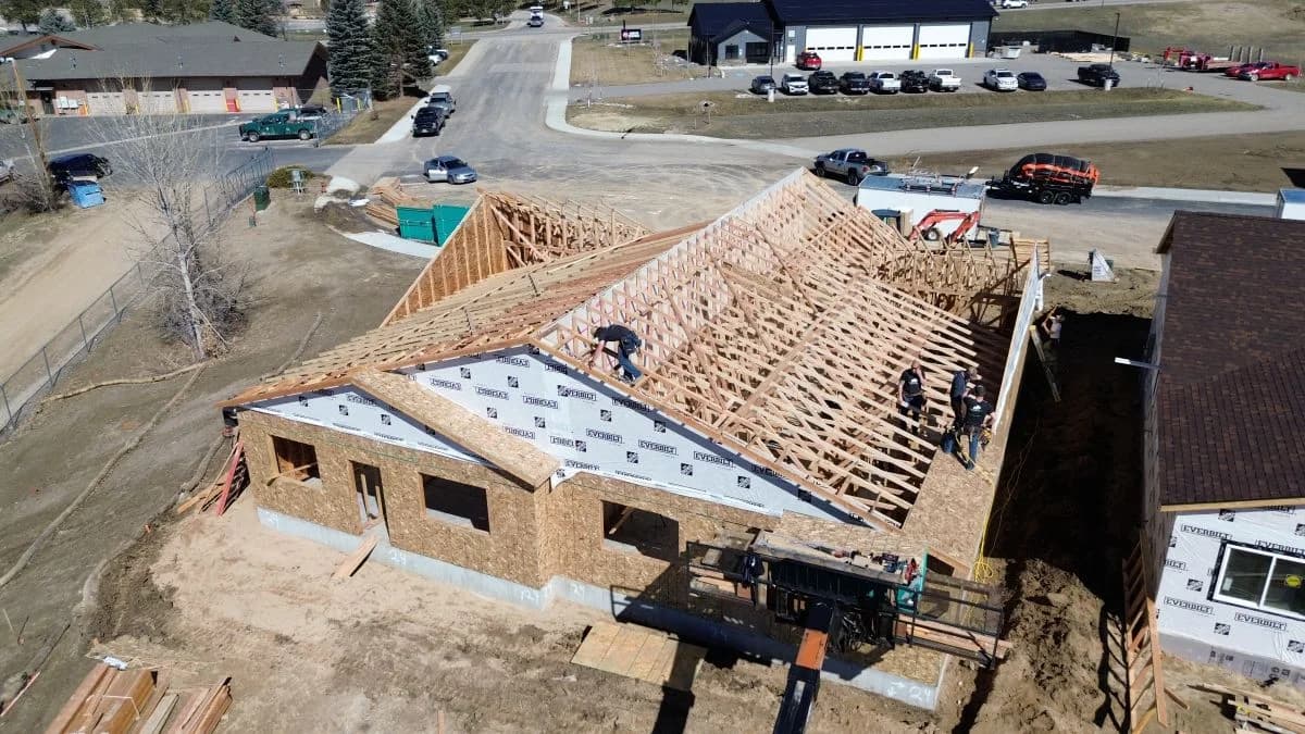 Active roof truss framing construction phase by Buffalo Built LLC, representing expert stick framing services in Wyoming.