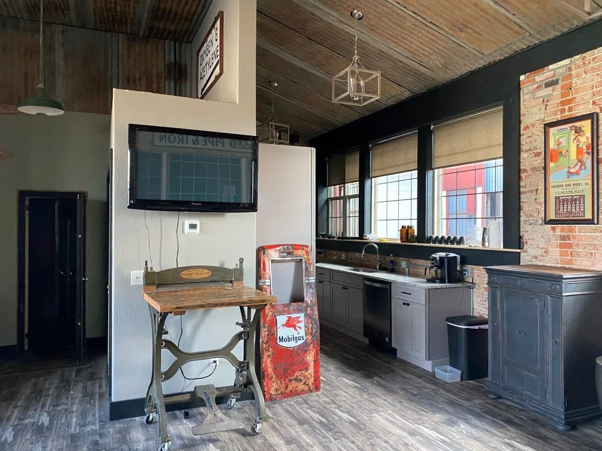 Open concept historic building renovation featuring an industrial loft kitchen and vintage decor by Buffalo Built LLC.