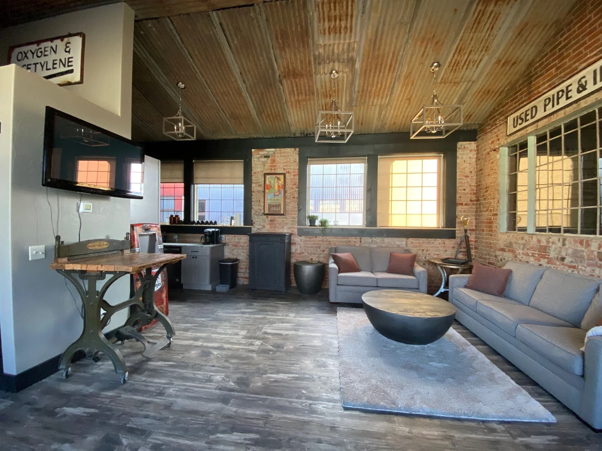 Industrial chic whole home renovation of a historic loft living room with exposed brick walls by Buffalo Built LLC.